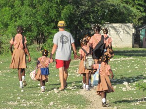 Jacob walking the children to school on their first day of school in their new home.