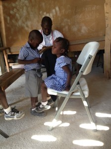 Dr. Shubert with two sweet children on mobile clinic