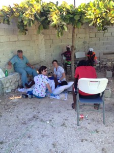 Kirsten and Karen with Tony and Alex laboring a mother under the almond tree