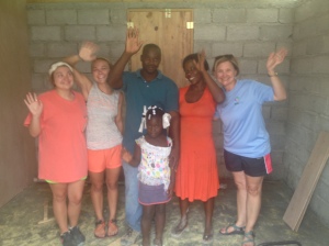 Some of the girls from the Natchez team with Nicoderm and his family after they built their house